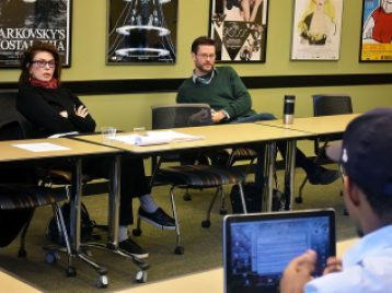 Sara Colleton and Oliver Thornton listen to Andre Ray pitch his idea
